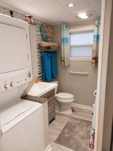 main house primary bathroom with washer and dryer