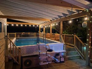 Nighttime heated pool with raised decking