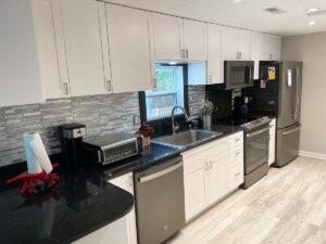 Newly remodeled kitchen with stainless steel appliances and quartz counters