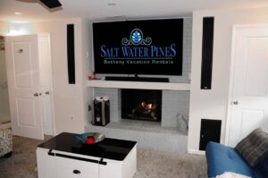 Deluxe family room with 72" HDTV with Amazon Prime, Netflix, and cable, gas fireplace, wine chiller, karaoke machine, Atrai game consoles, and surround sound
