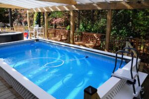 Heated swimming pool with clear awning cover