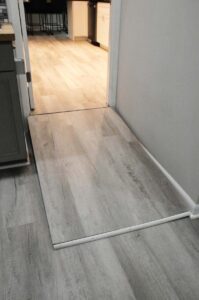 Wheelchair ramp from family room into main house via kitchen