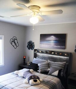 Bedroom 3 with double bed, fireplace, large LED TV, ceiling fan, and whole house sound