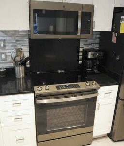Gourmet kitchen with stainless appliances and quartz counters