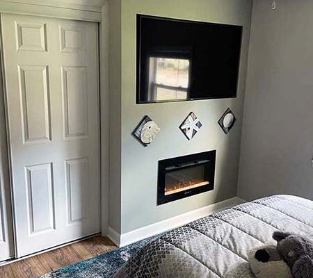 Bedroom 3 with double bed, fireplace, large LED TV, and whole house sound
