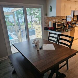 Dining room opens to kitchen with view of pool