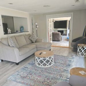 Living room opens to family room with French doors and privacy blinds when needed