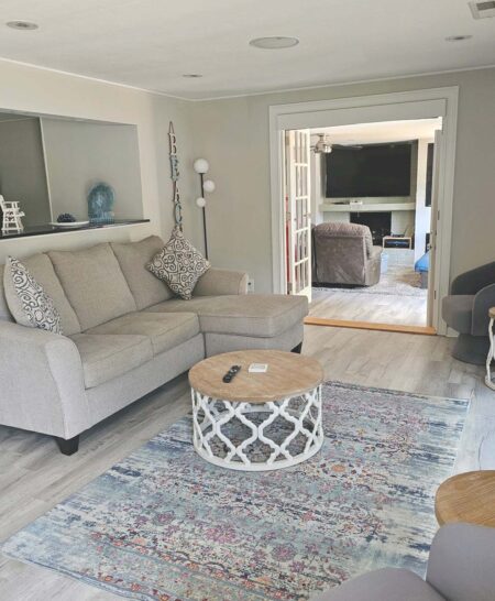 Living room opens to family room with French doors and privacy blinds when needed