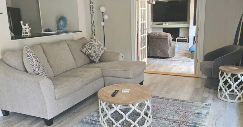 Living room opens to family room with French doors and privacy blinds when needed