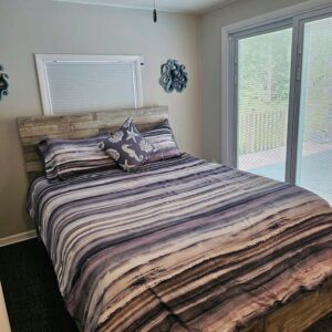 Bedroom 2 has a view of pool area and rear deck with built in privacy binds inside the sliding doors.